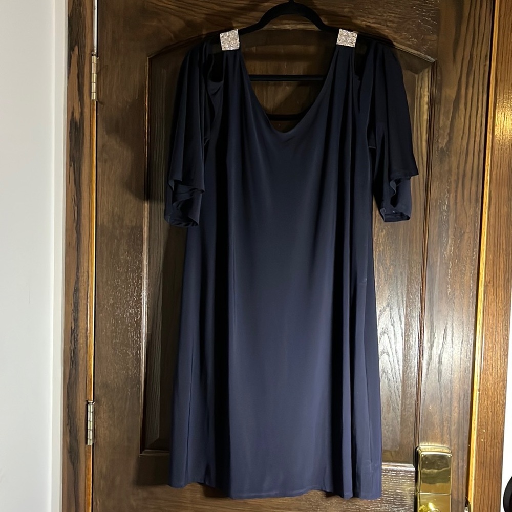 Navy shift dress with open shoulder and rhinestones on the shoulder.